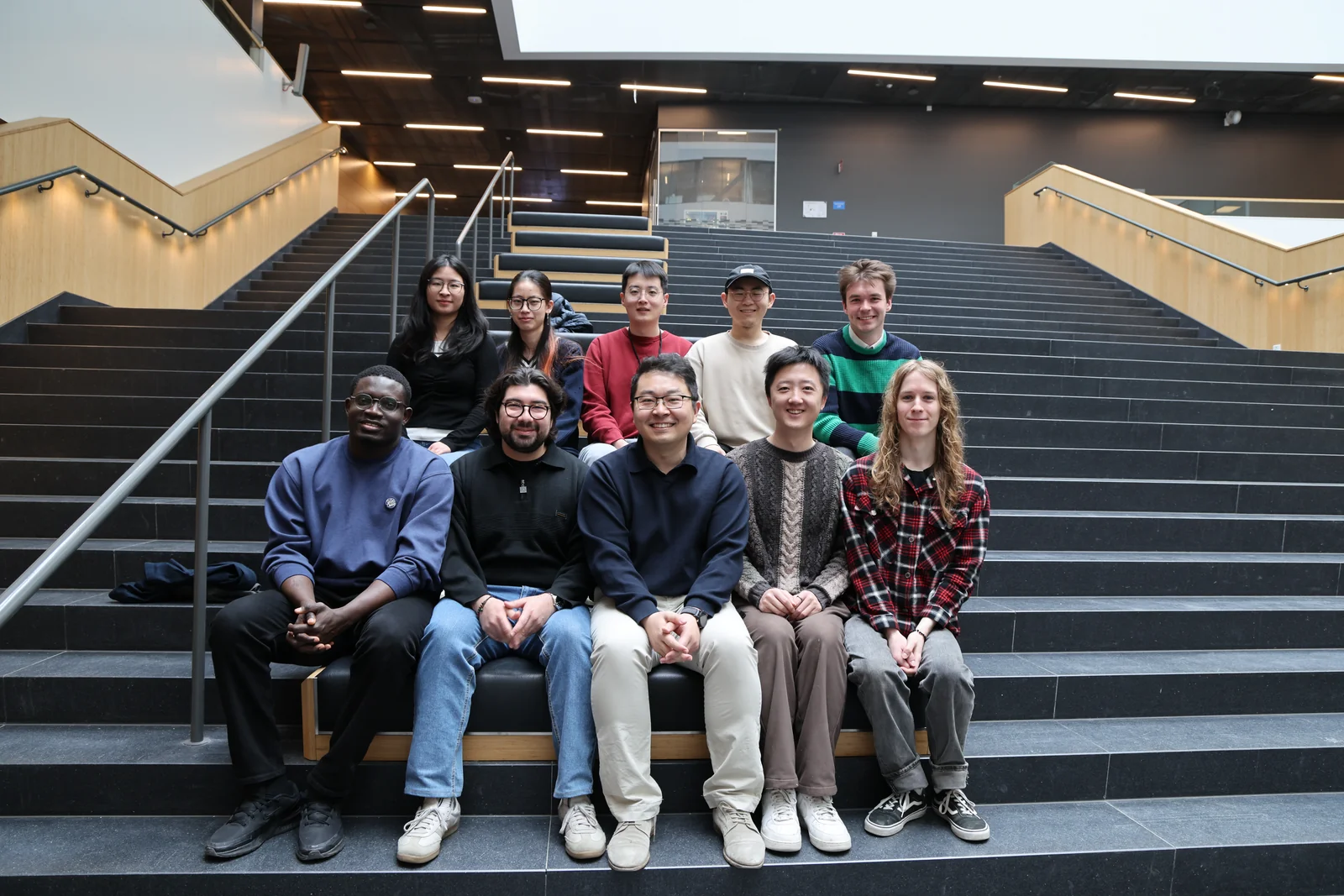 Research group gathered on the stairs at Ångström Laboratory